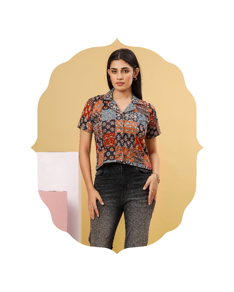 Woman wearing a patterned shirt and jeans on a beige background